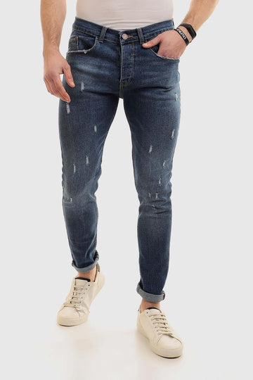 بنطلون جينز قطني بقصّة Slim Fit مع خدوش - غسيل قياسي باللون الأزرق